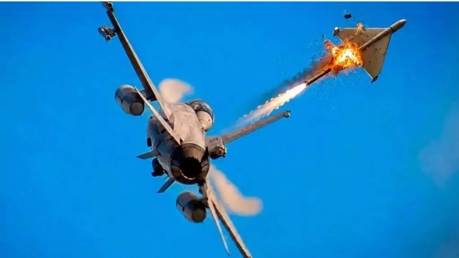Истребитель F-16 запускает ракету, поражающую дрон в голубом небе